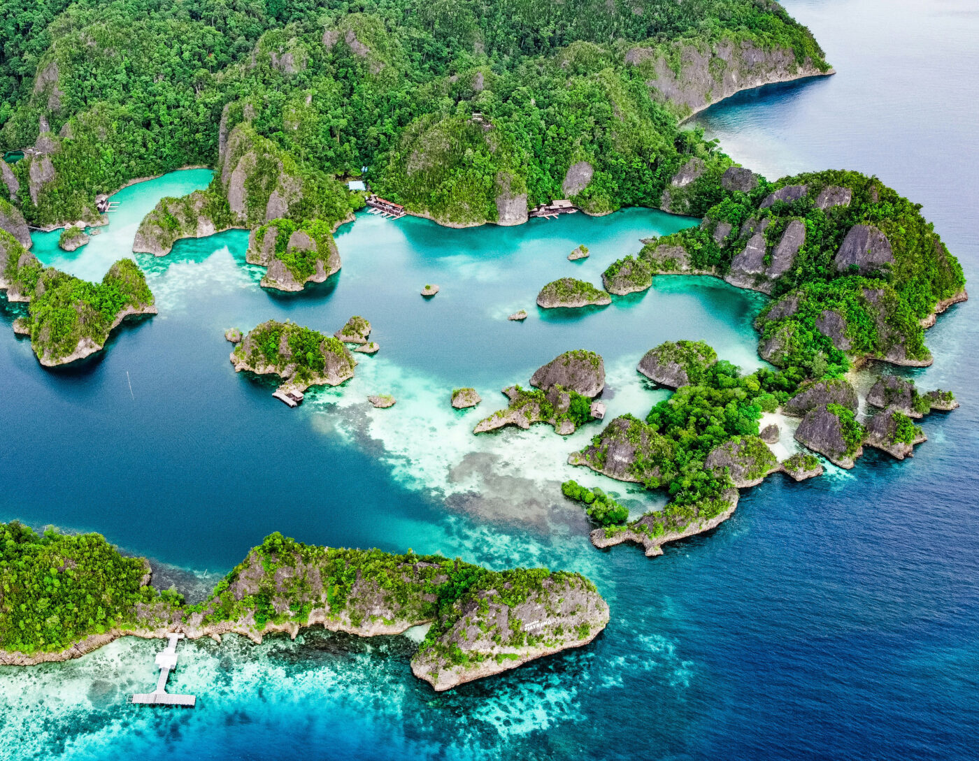 Aerial view of Piaynemo islands in Raja Ampat with turquoise lagoons.