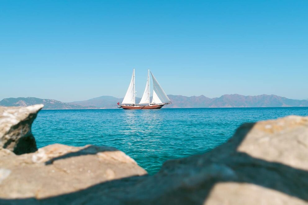 Sailing yacht on the horizon at sunset in Turkey