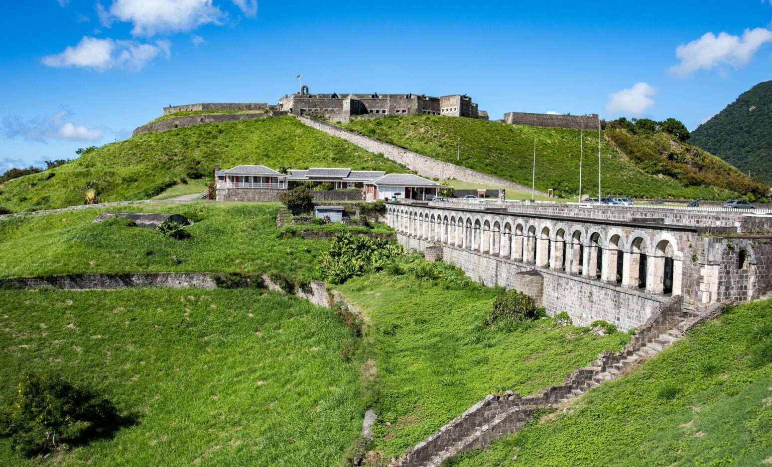 Brimstone Hill Fortress National Park, a large stone fortress complex on a green hill.