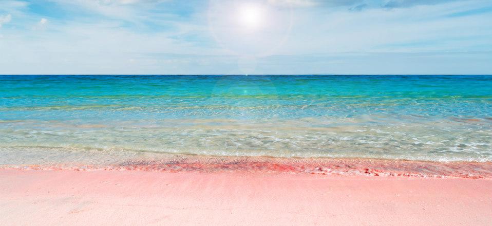 The famous Pink Sands Beach on Harbour Island, known for its blush-colored sand and tranquil sea