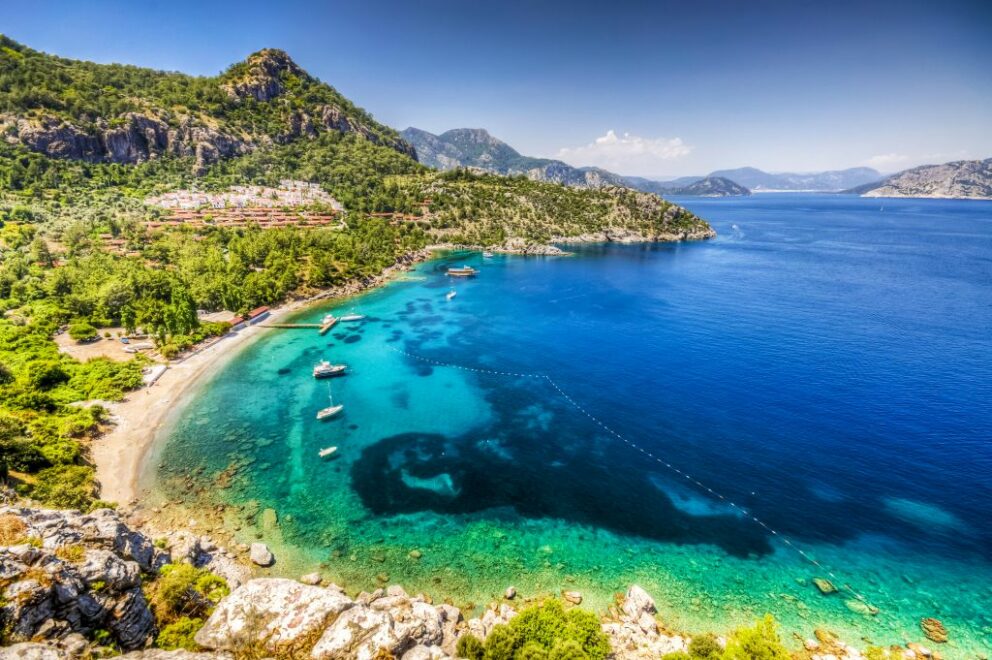 Marmaris beach with vivid blue water and forested hills