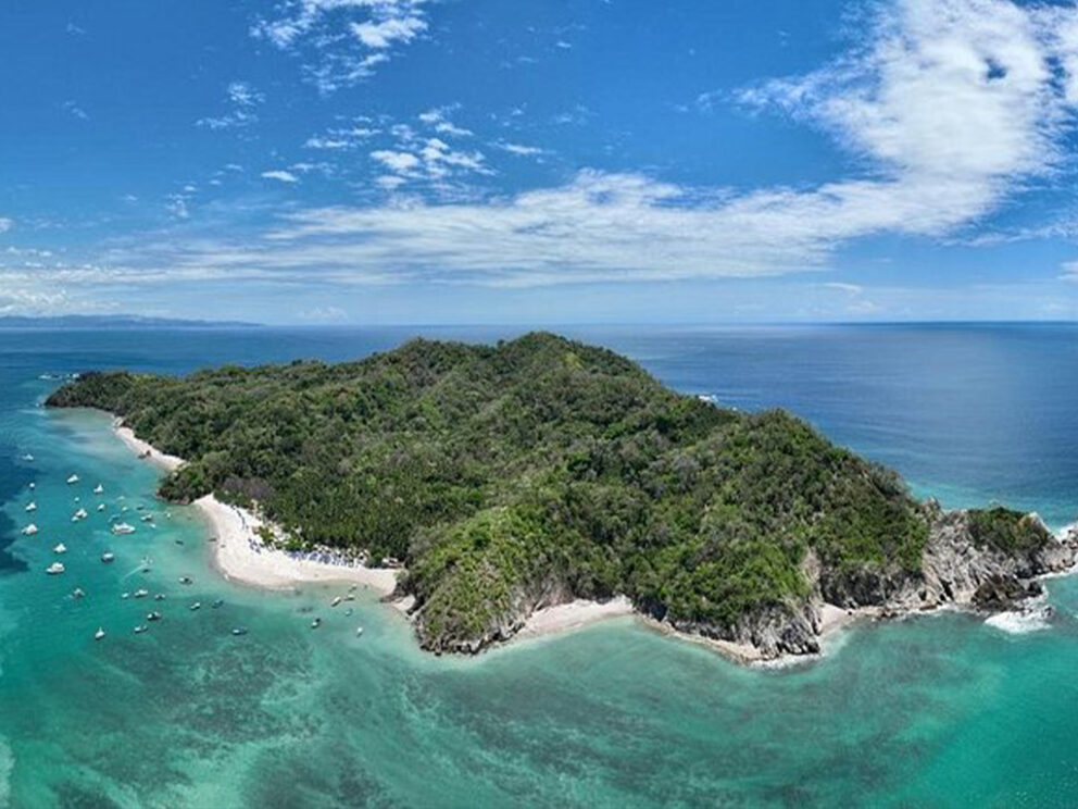 tortuga island in costa rica with some yachts anchored around