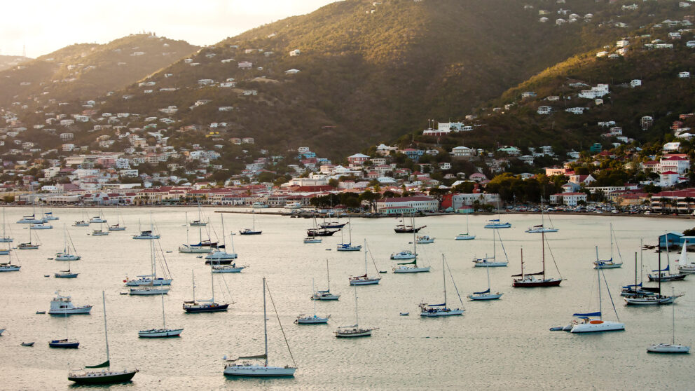 panoramic view of Charlotte Amalie harbor in St. Thomas, U.S. Virgin Islands, featuring numerous sailboats and yachts anchored in the calm