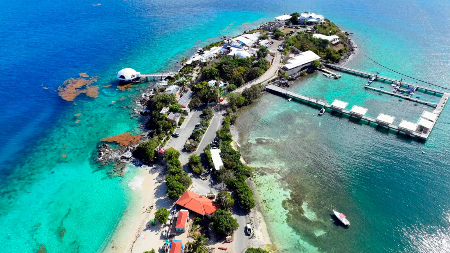 An aerial view of Coral World Ocean Park and Coki Beach on a sunny day in the Caribbean.